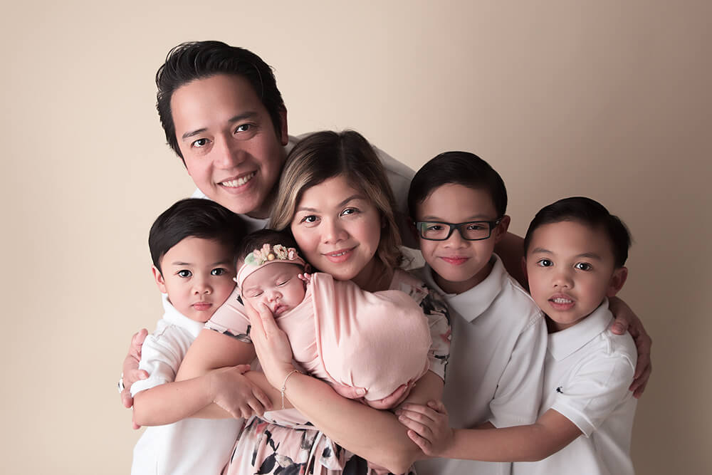 Family Poses Together For A Newborn Photography Session