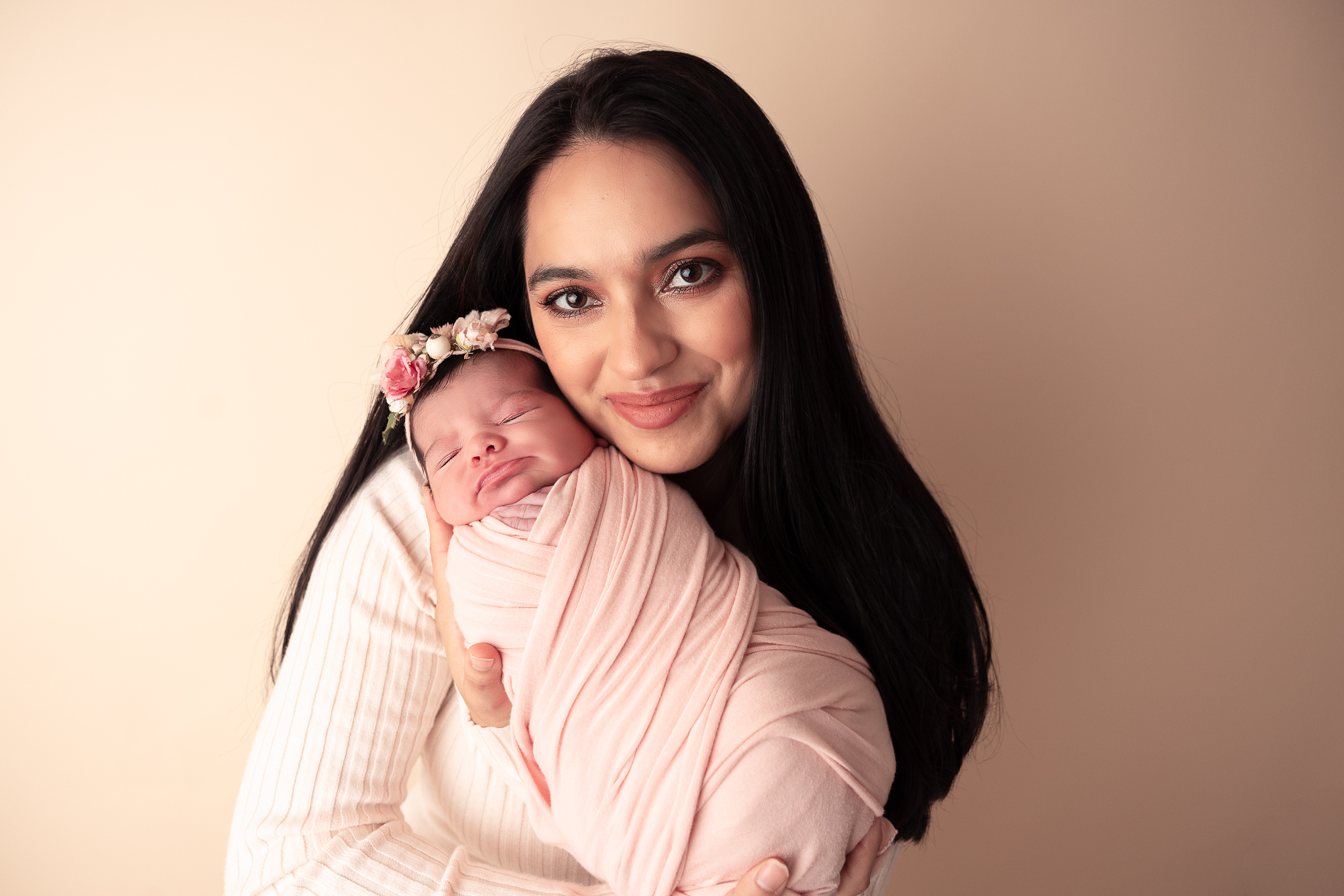 Mom Holding newborn baby that is wrapped