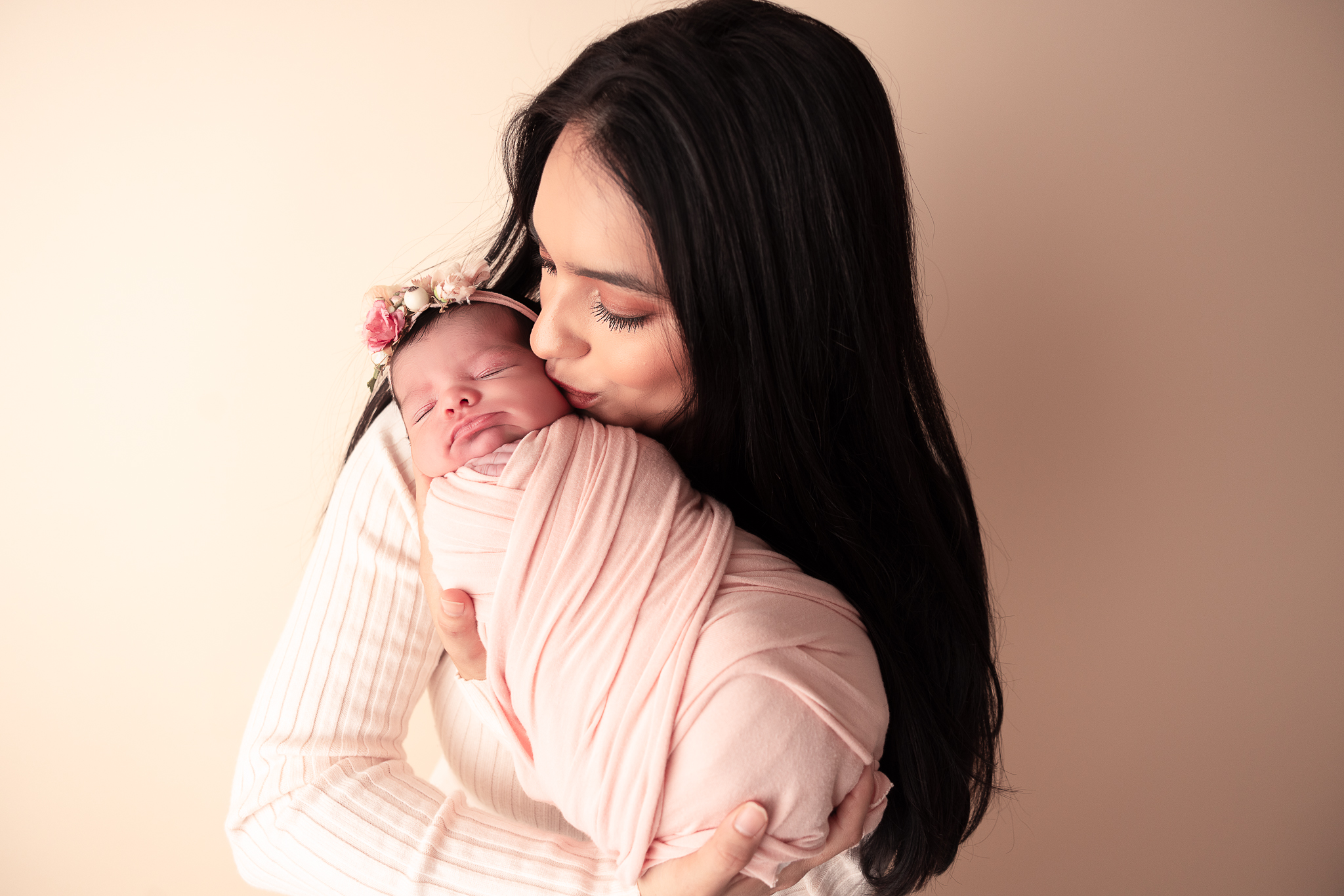 Mom kissing baby