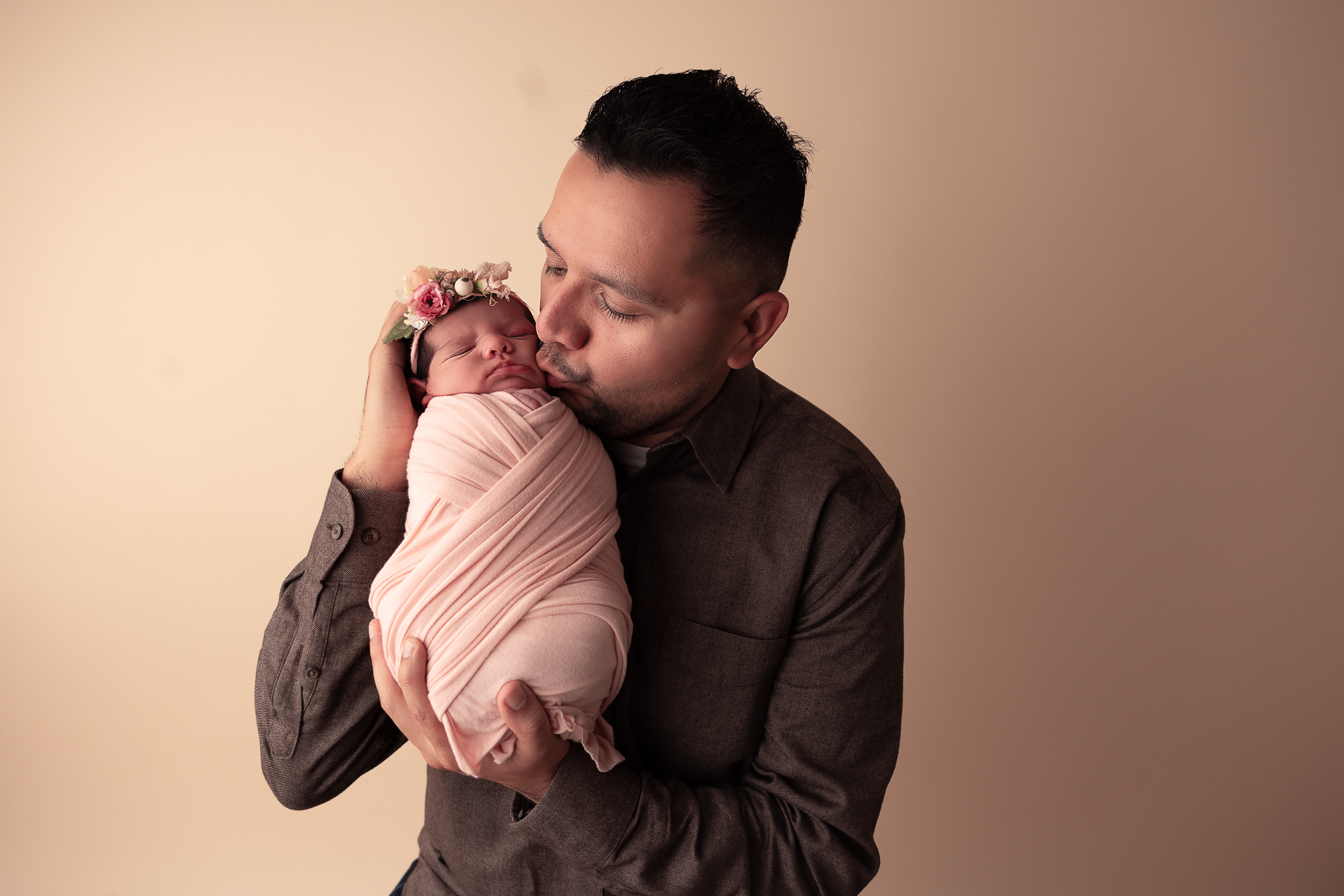 Dad kissing baby