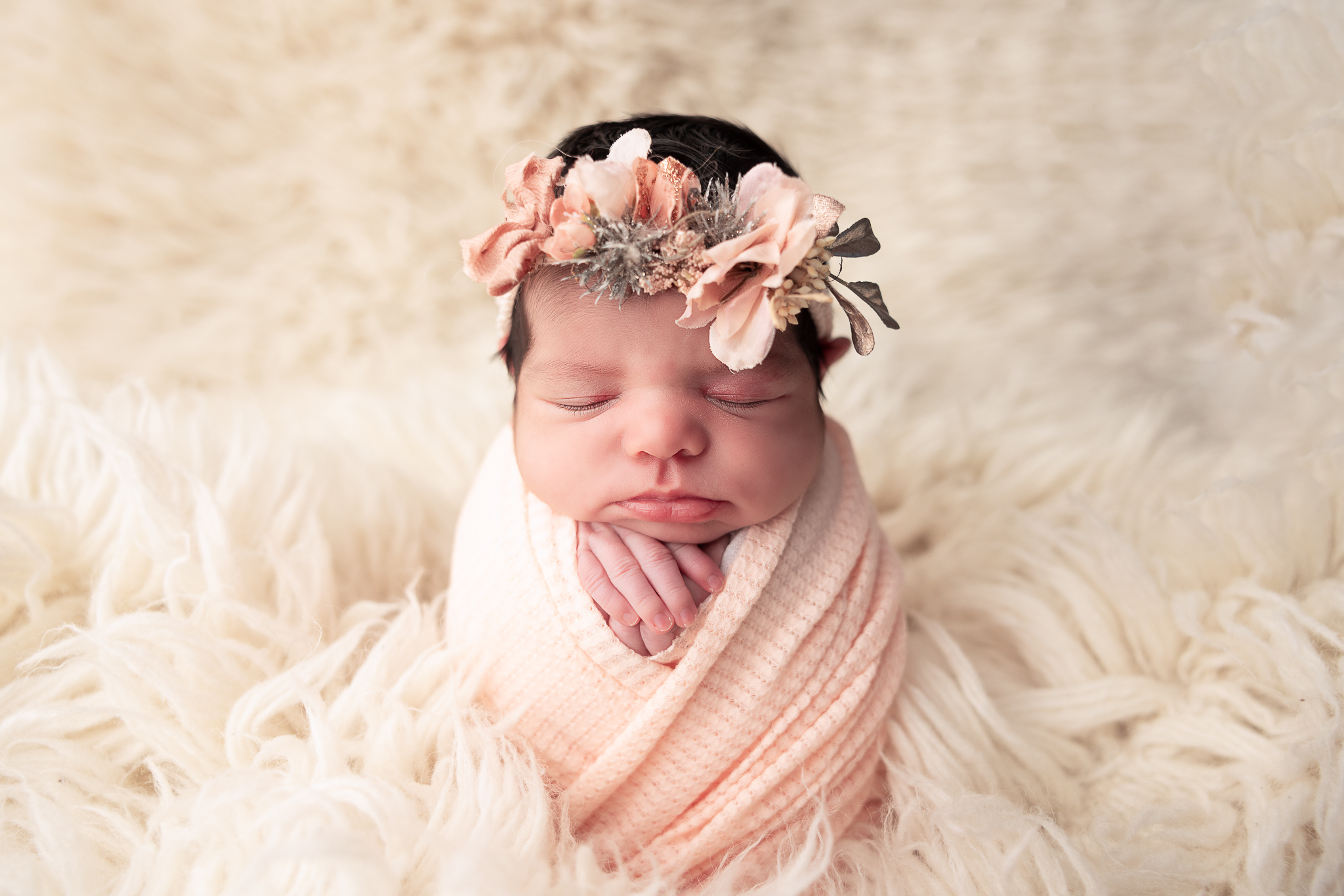 Baby wrapped in peach with floral headband