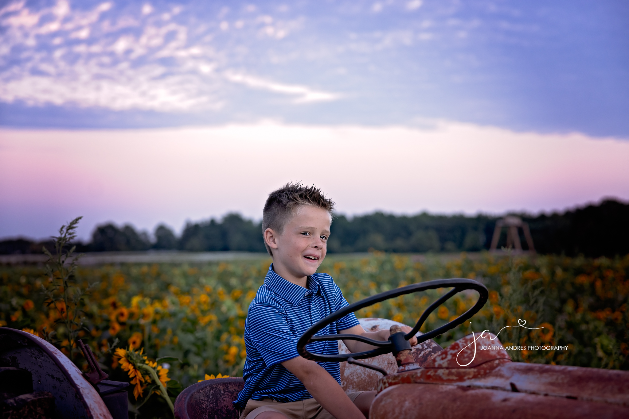 boy on a tractor giving a silly face