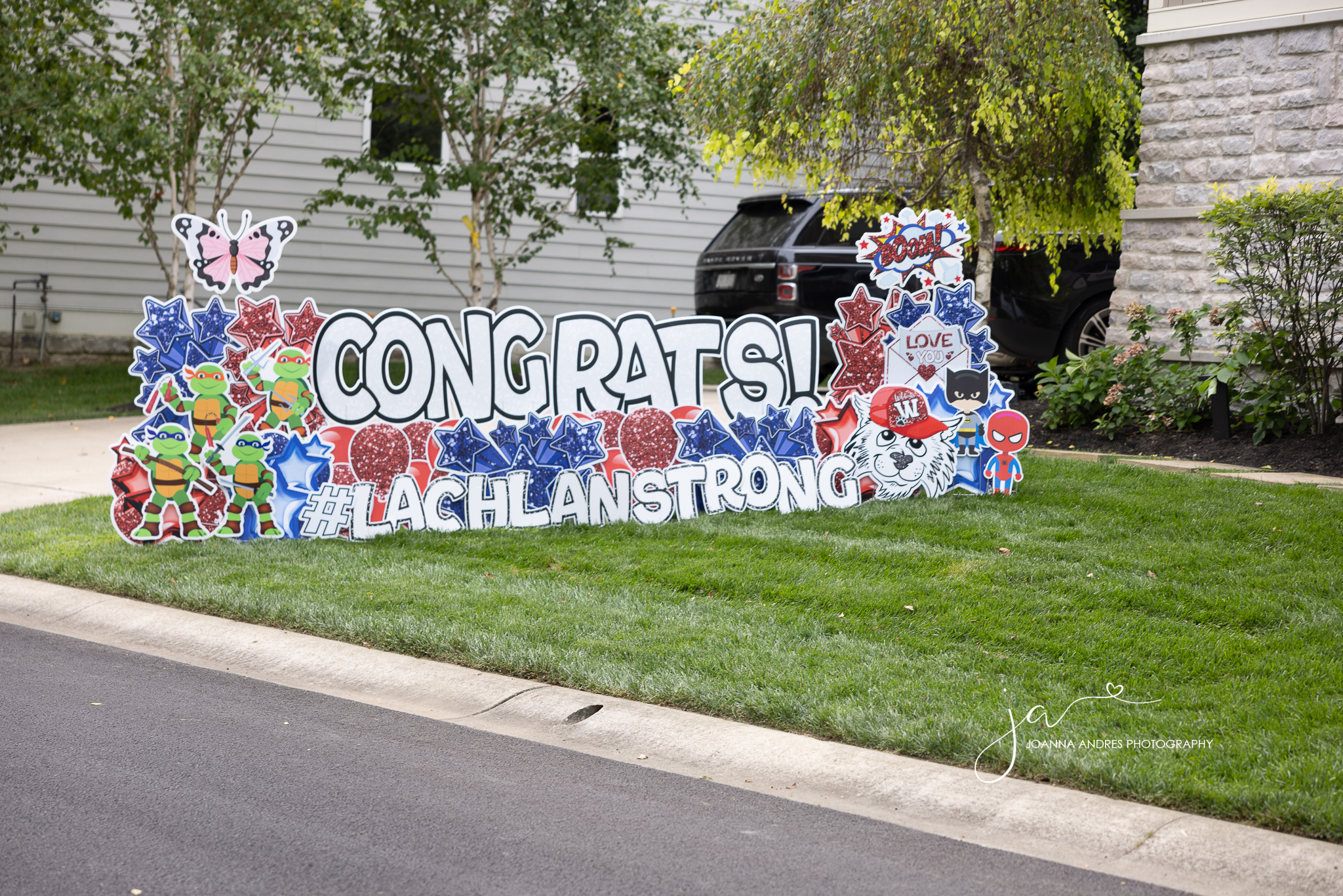 Yard Sing that says Congrats and #Lachlan Strong with balloons