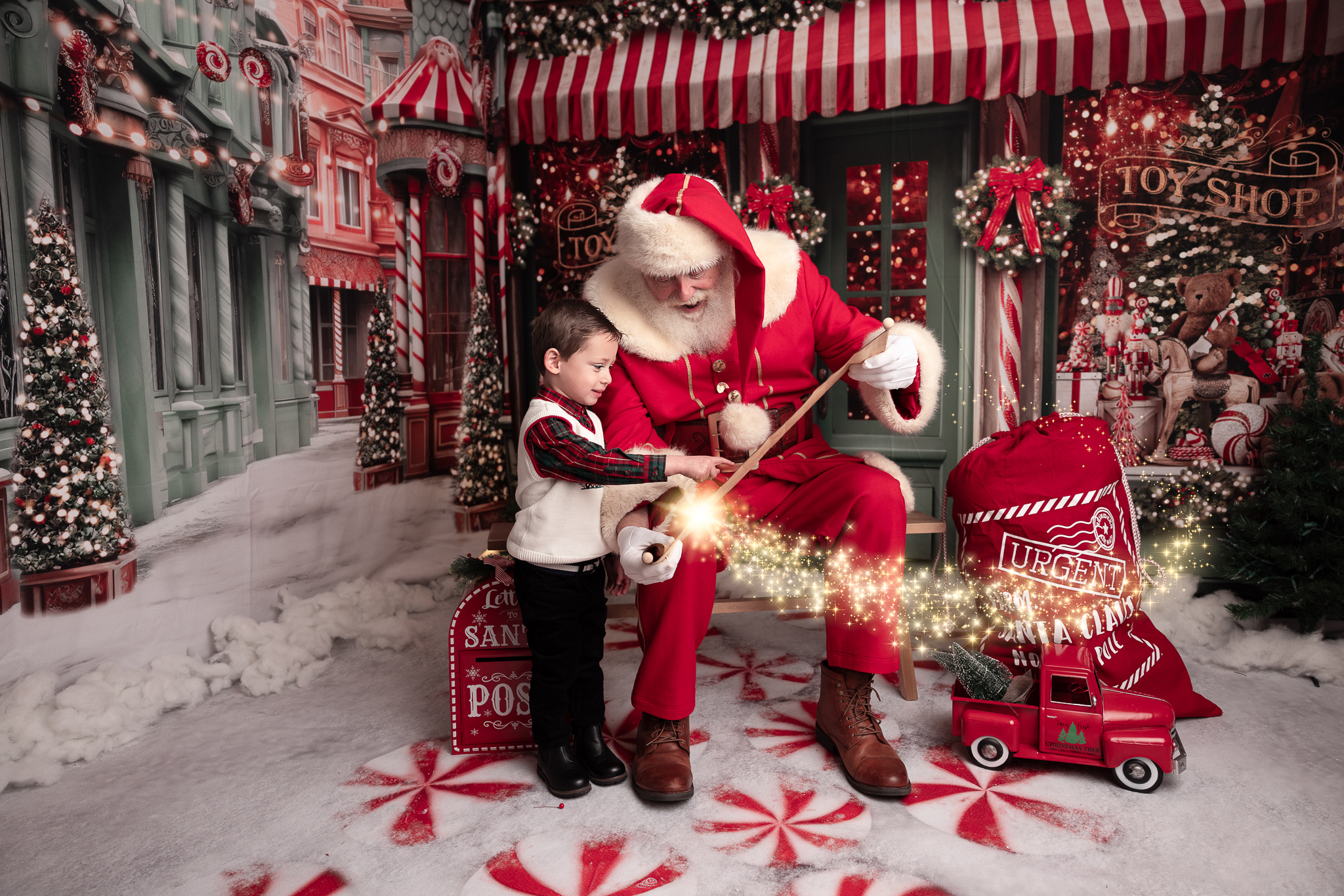 little boy pointing to his name on the nice list that santa is holding