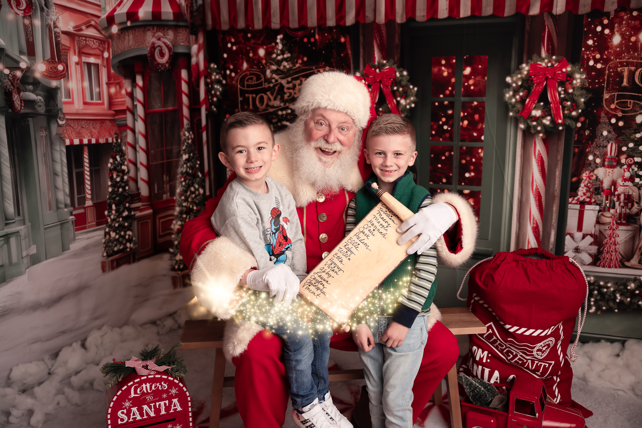 siblings holding the nice list sitting on santas lap