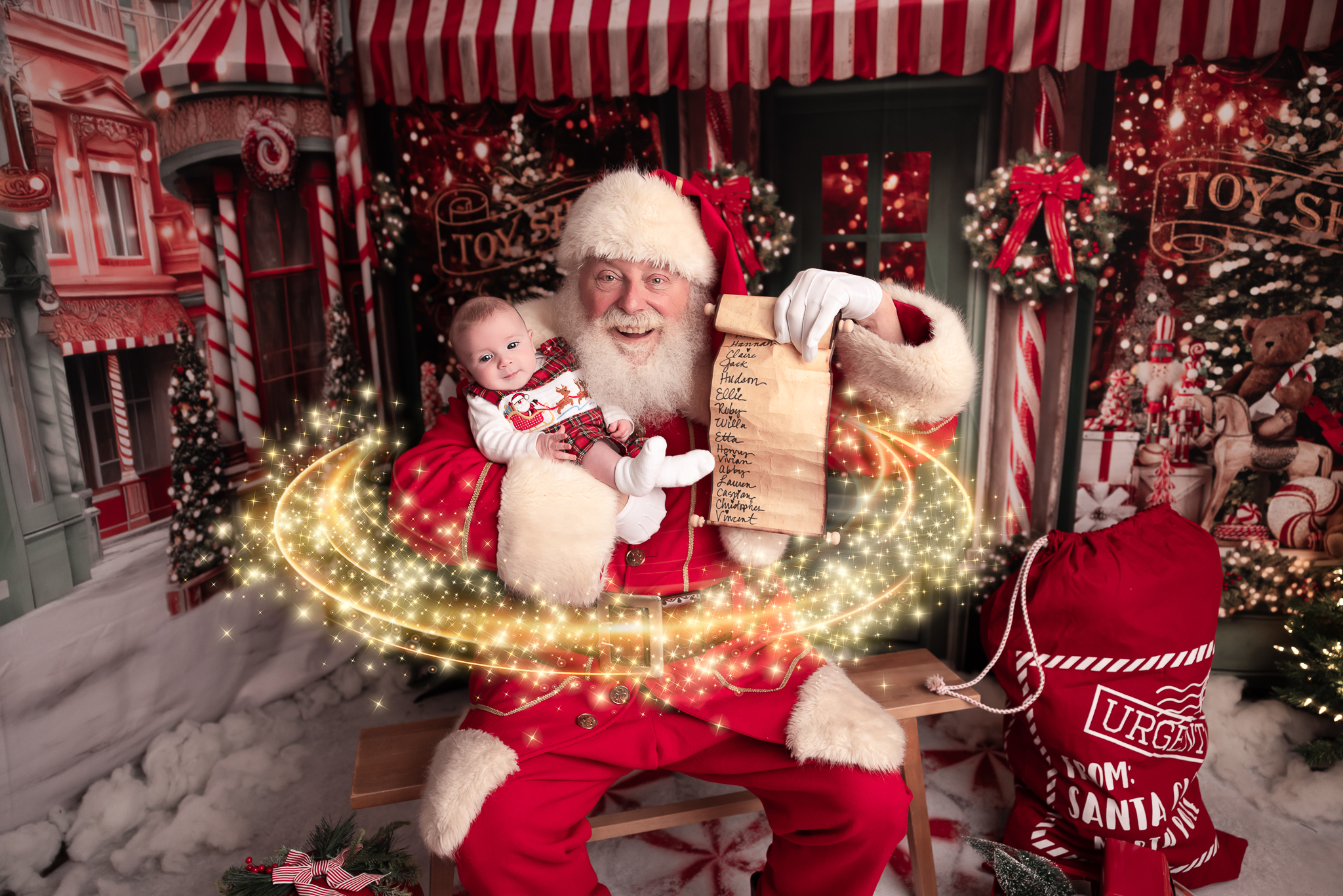 Santa holding a baby boy holding up the nice list with magic surrounded