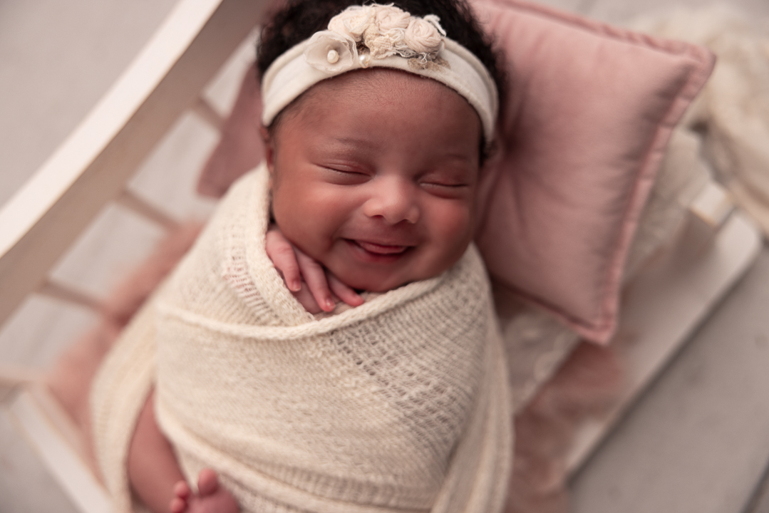 baby smiling with tongue sticking out