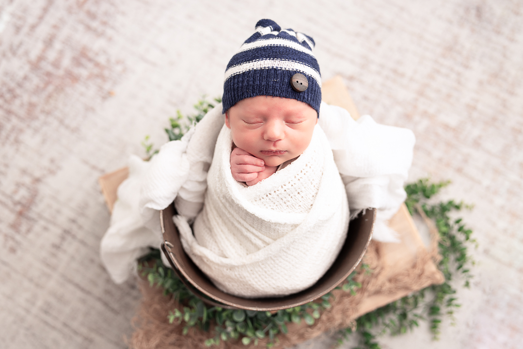 Baby wrapped and placed in a bucket