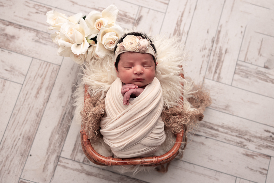 baby wrapped in neturals withe florals