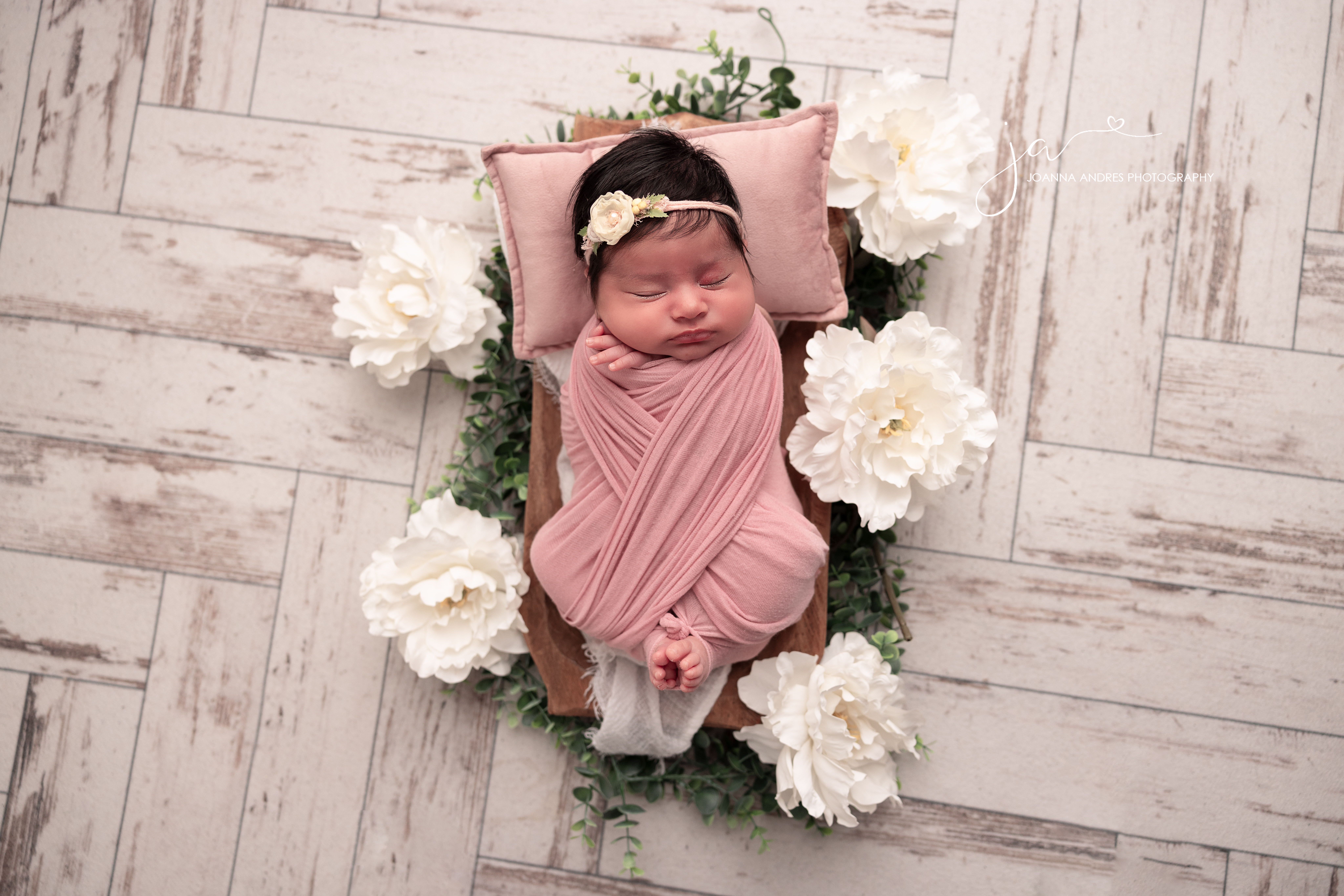Baby wrapped in pink with white florals