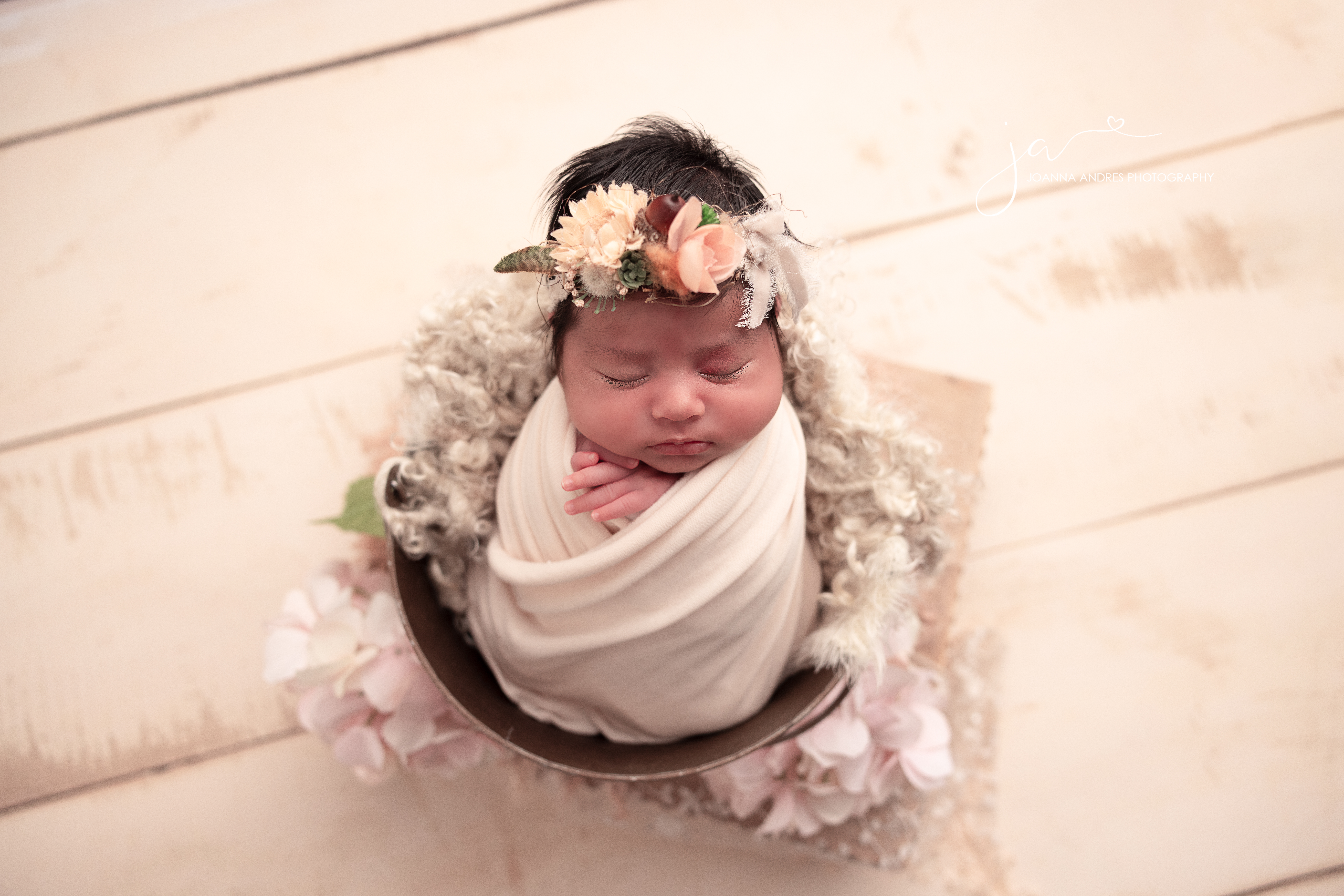 Baby in a bucket wrapped in cream