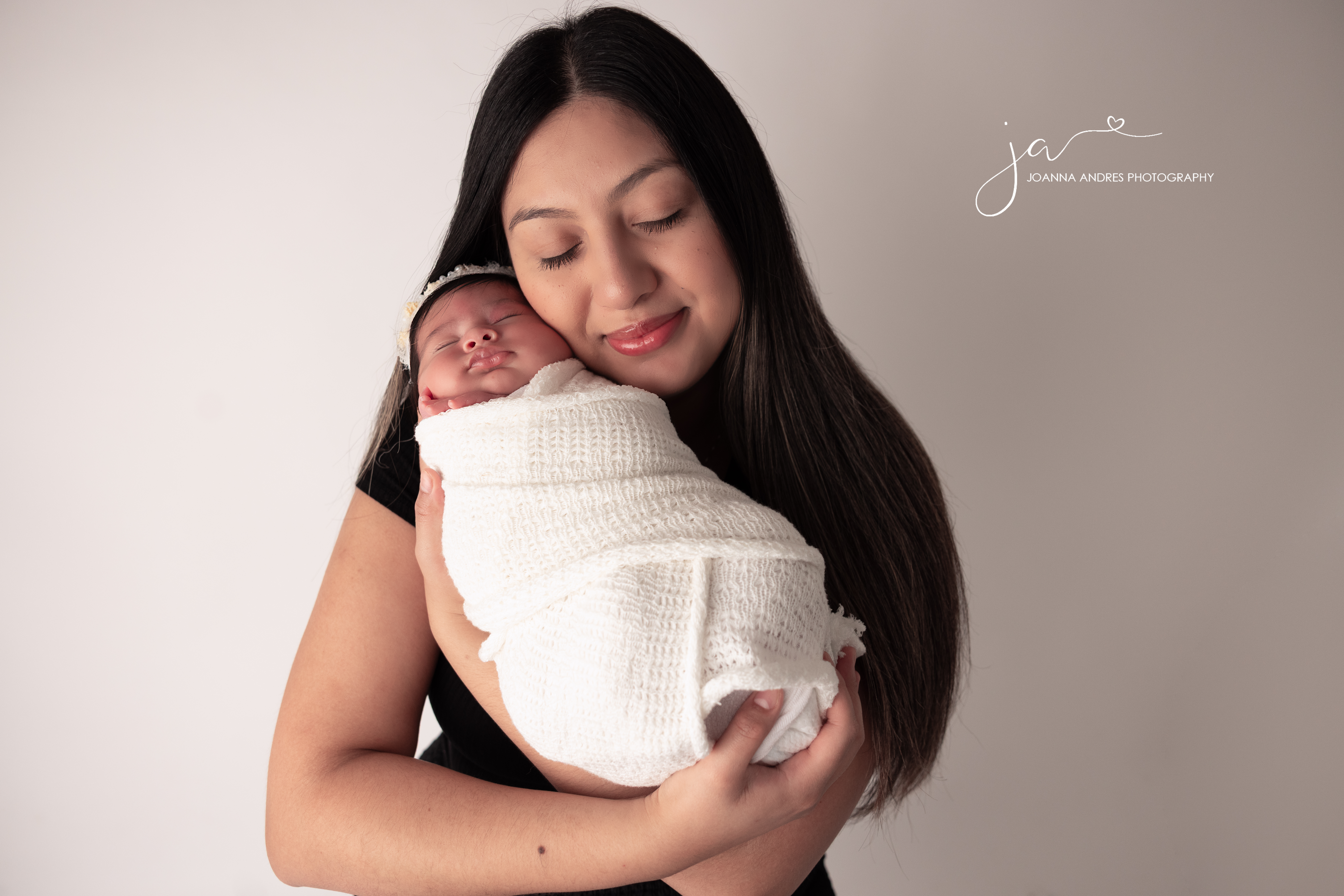Mom with eyes closed holding her baby