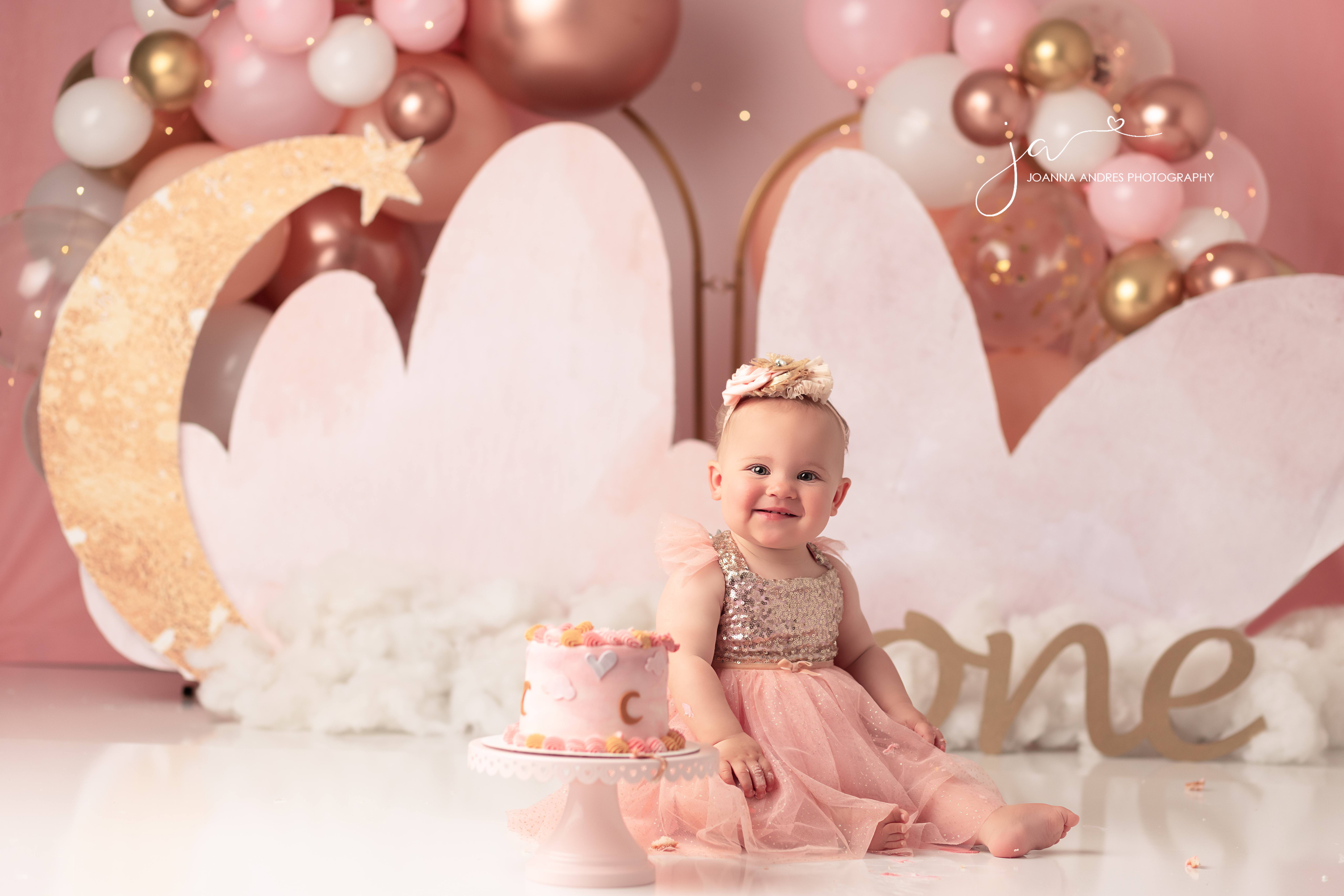 Baby smiling for a cake smash session