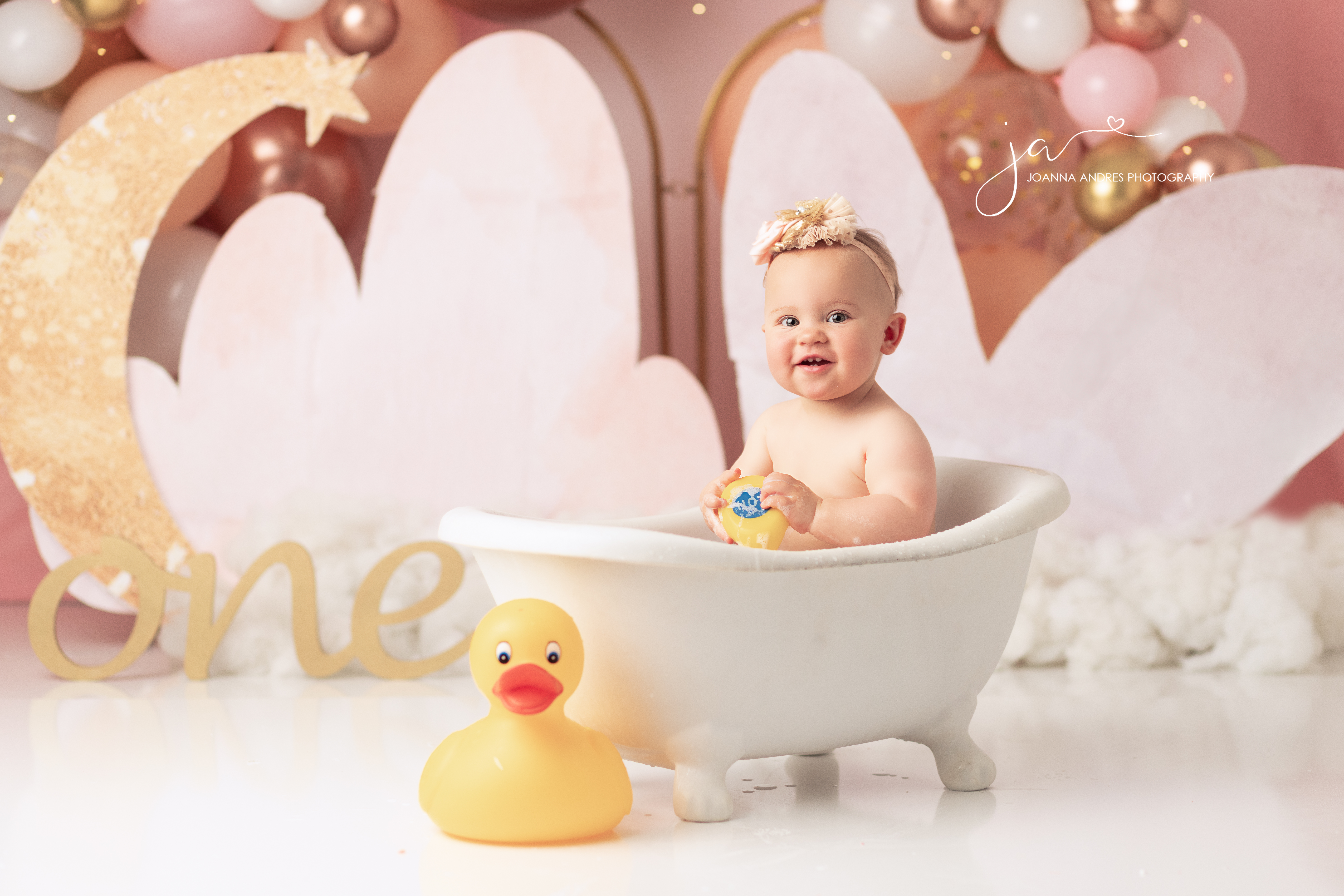 Baby in bathtub with rubber ducky
