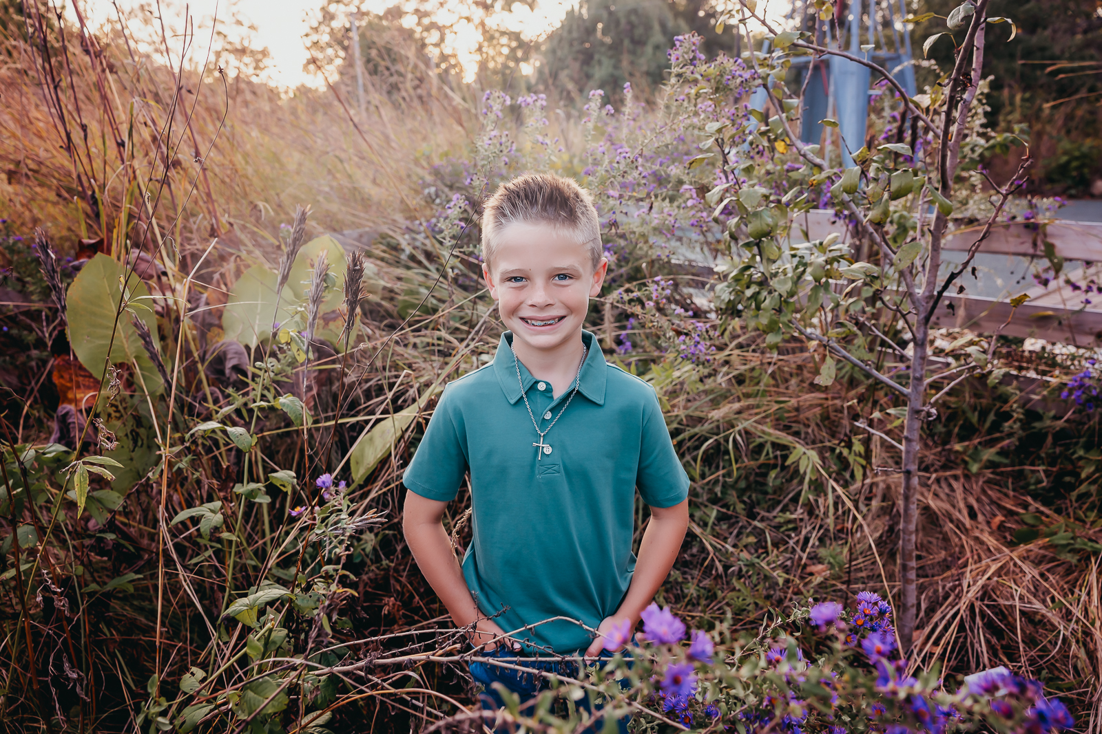 LIttle boy wearing a green shirt taken in the middle of wildflowers at Innis Woods Metro Garden