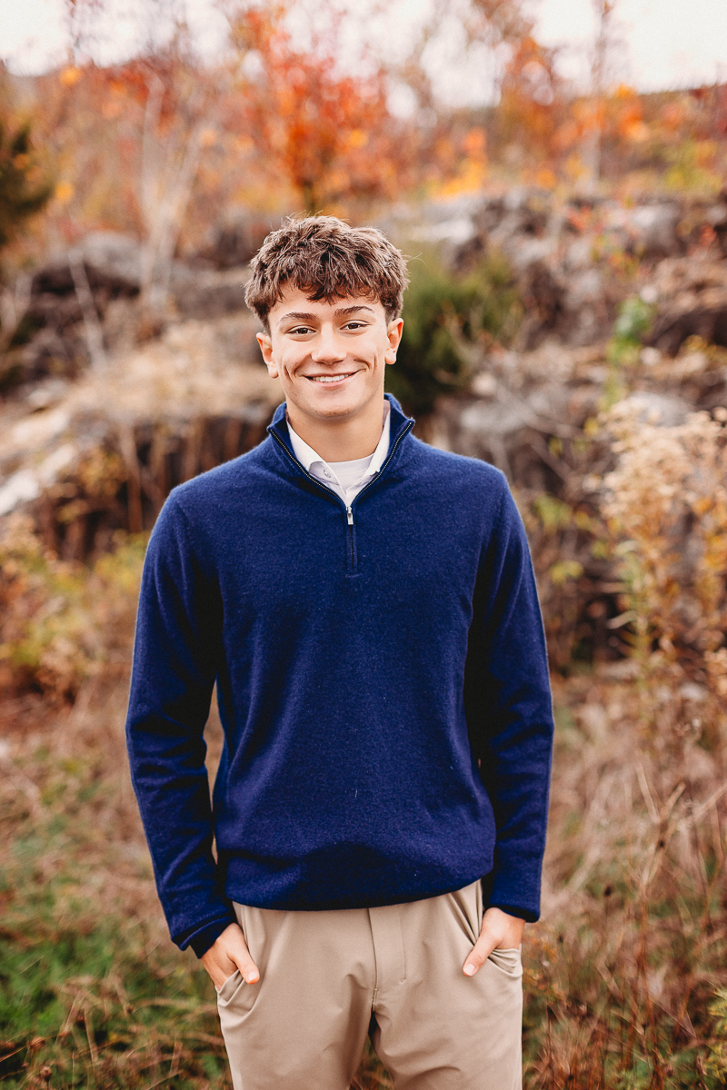 senior pictures with stones and high grass taken at quarry trails park