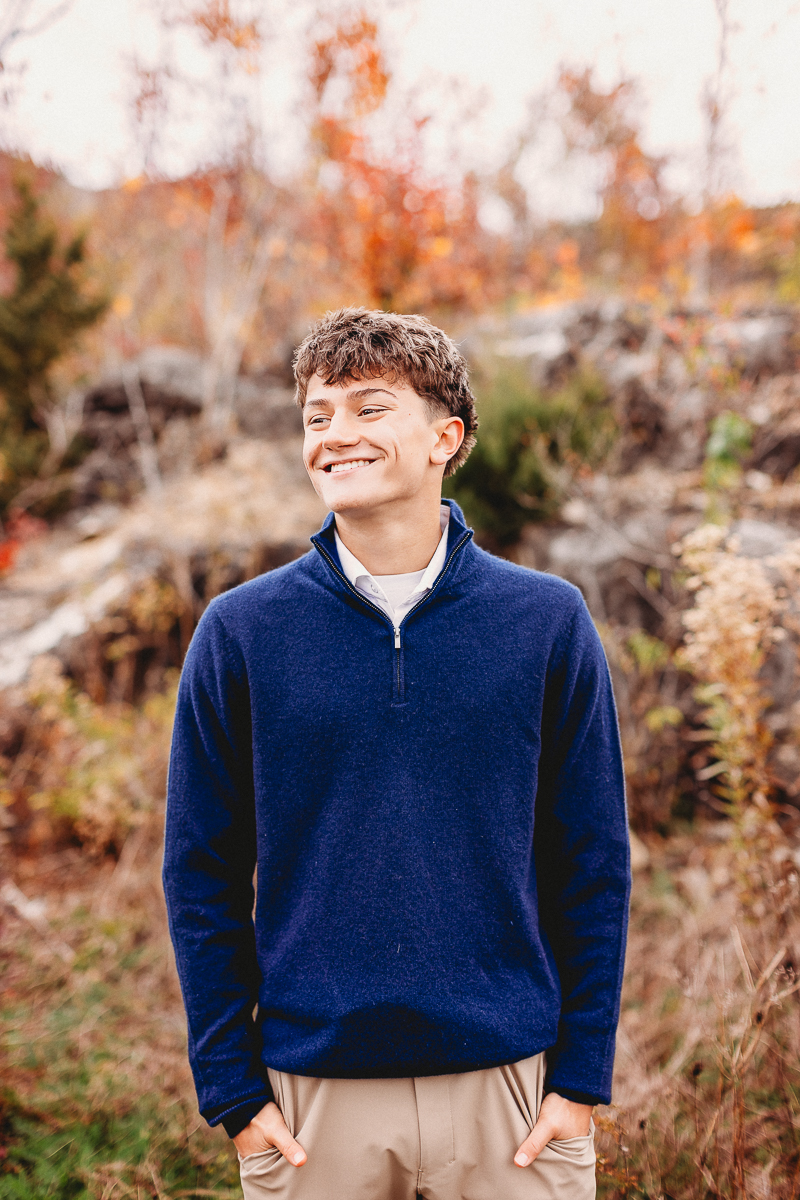 senior photo of male looking away from camera smiling taken at quarry trails park
