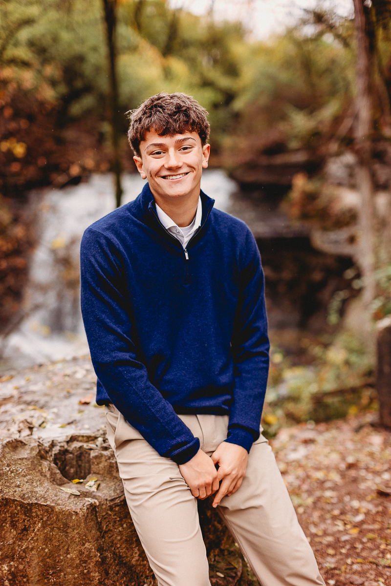 senior pictures with waterfall backdrop taken at quarry trails park