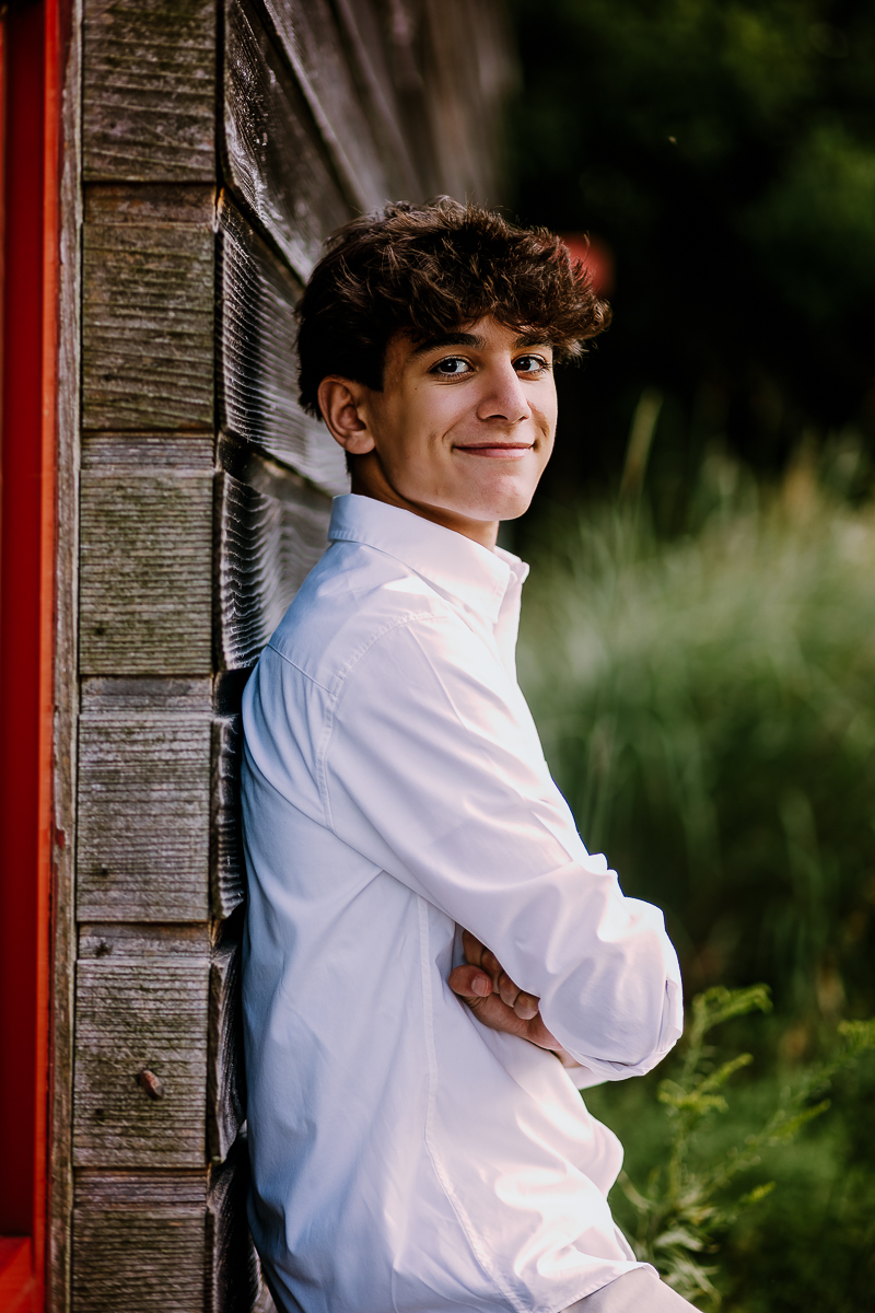 senior portrait leaning against wall