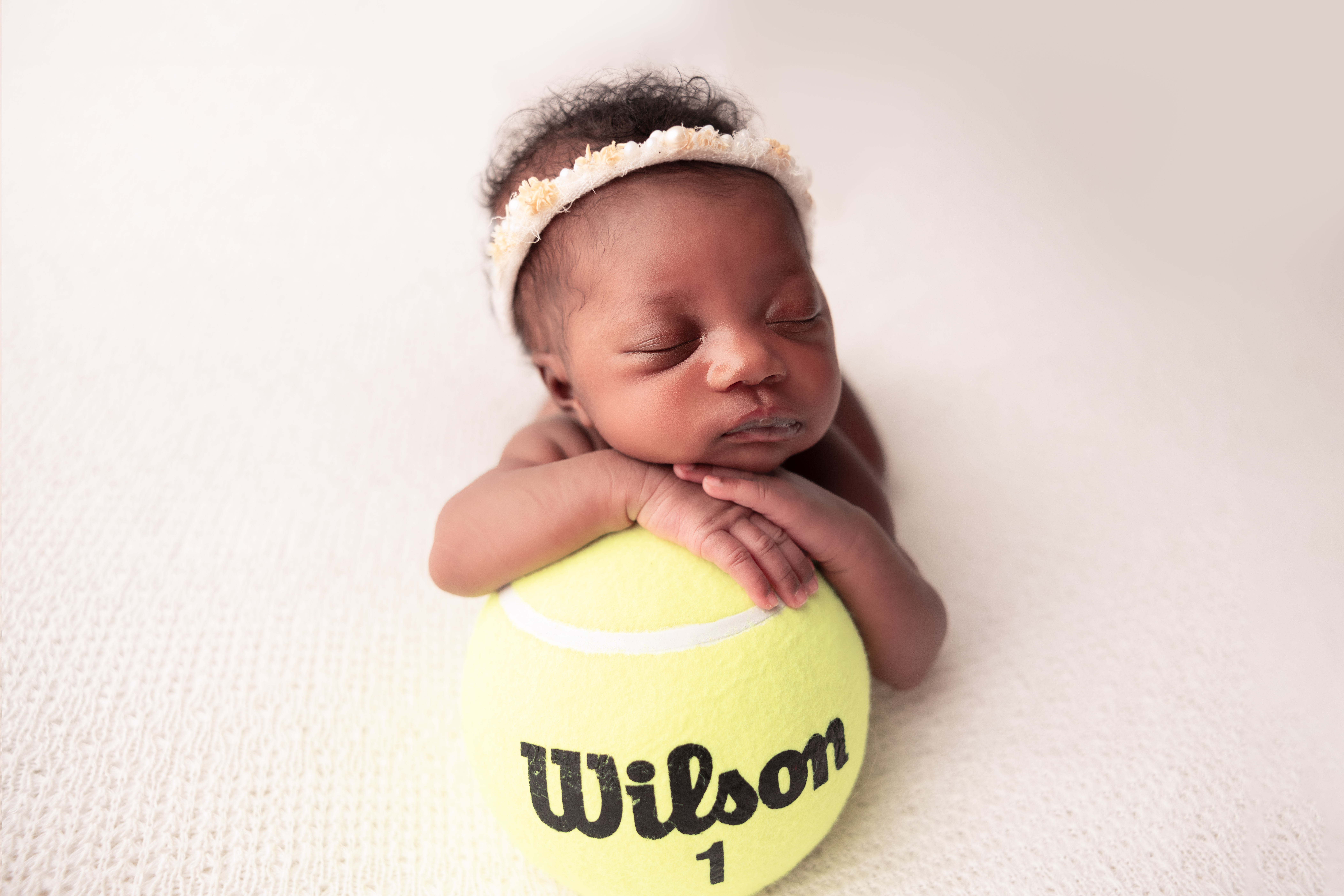 baby girl on a wilson tennis ball popular girl names in columbus