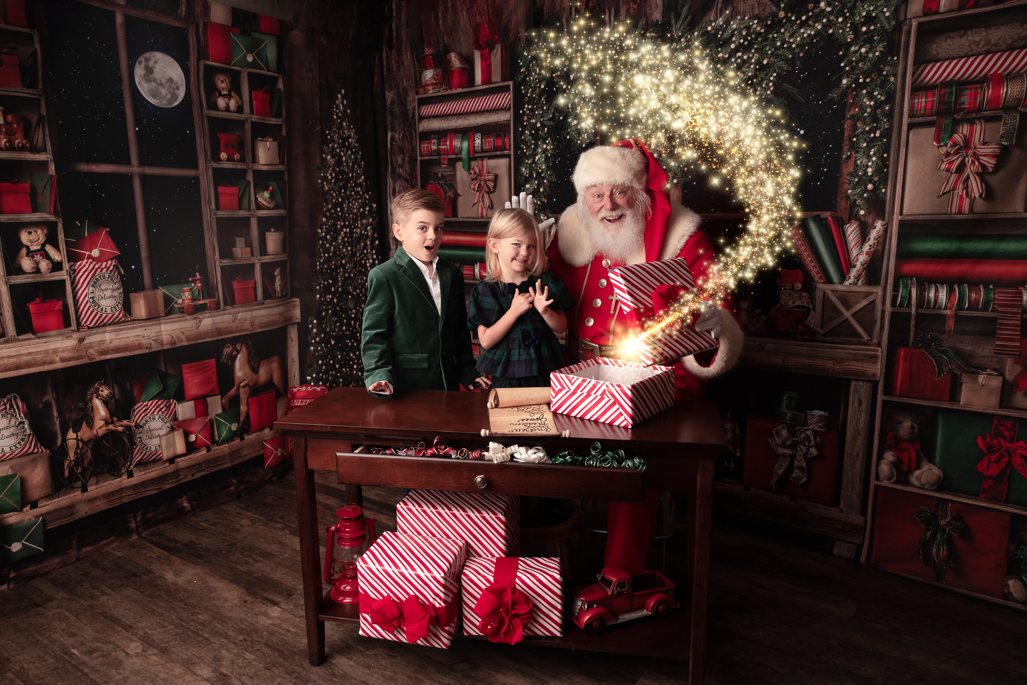borther and sister dressed in a green velvet jacket and plaid dress for their luxury Santa portraits