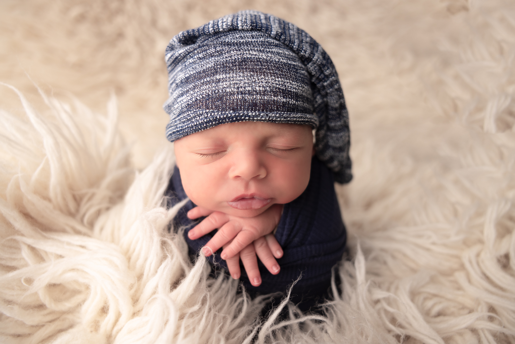 A classic newborn photograph highlighting the fleeting beauty of a baby's first weeks in Columbus.