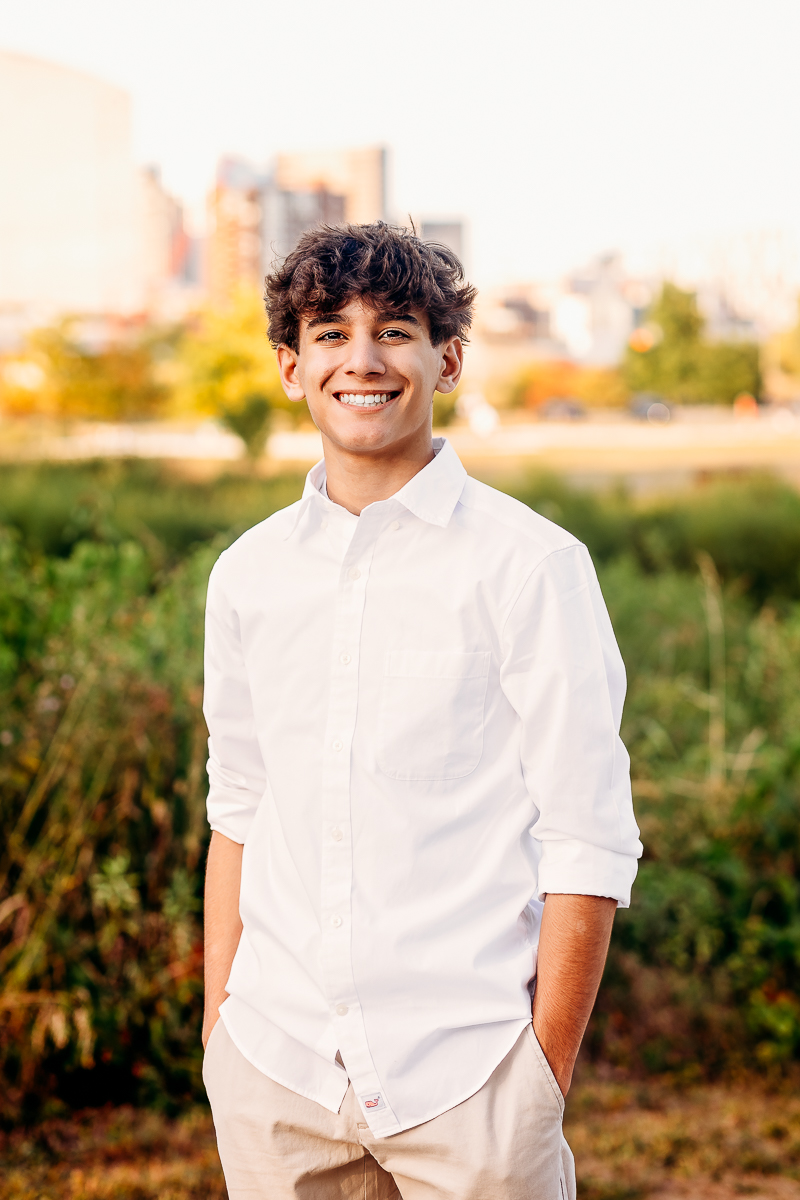 handsome senior high school boy with hands in pocket with columbus city skydrop at Scioto Audobn